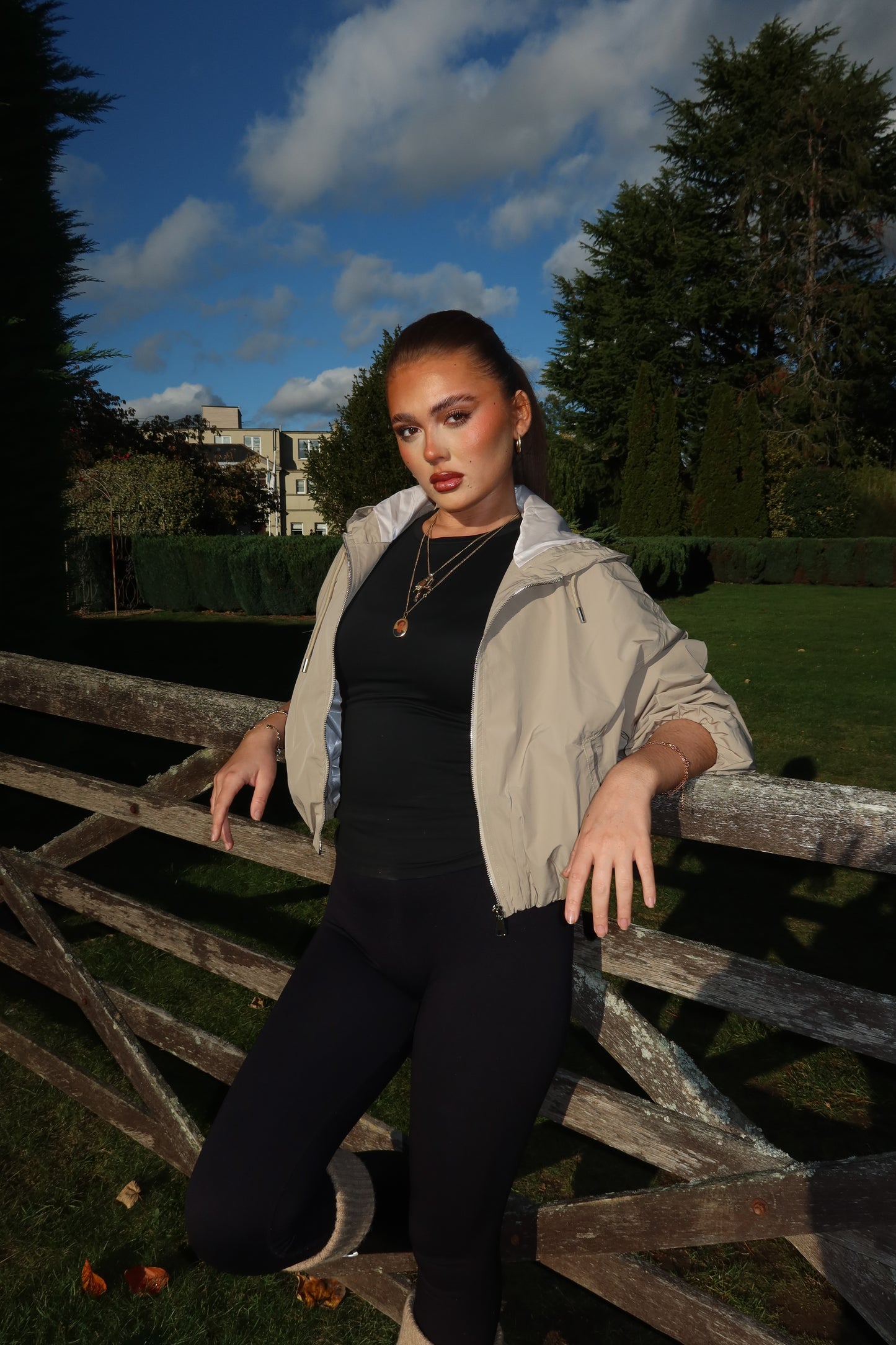 The beige cropped zip up hood jacket