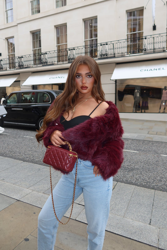 The burgundy faux fur coat